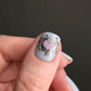 single-manicured-nail-with-a-swirling-heart-layered-nail-art-design
