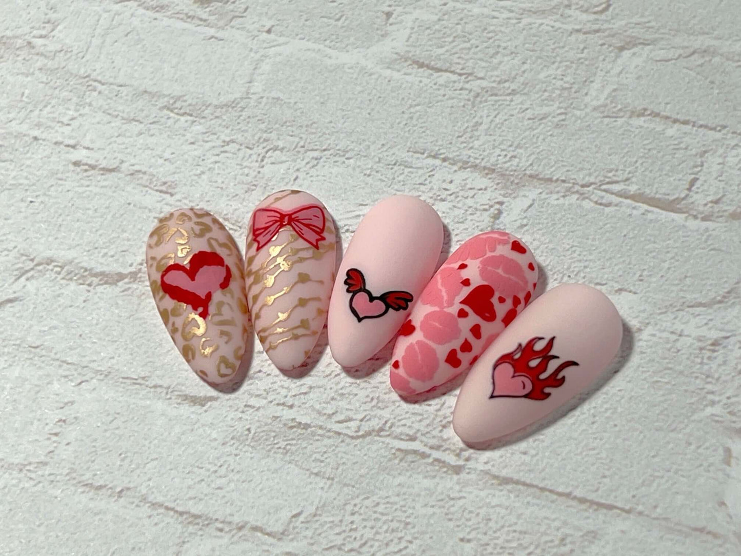 set-of-nail-tips-with-stunning-layered-nail-art-designs-of-hearts-lips-and-bows