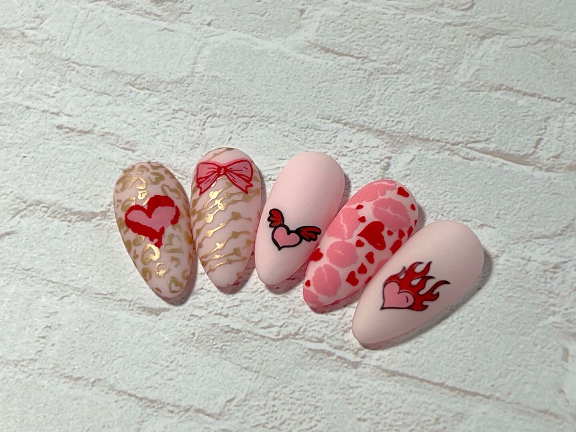 set-of-nail-tips-with-stunning-layered-nail-art-designs-of-hearts-lips-and-bows