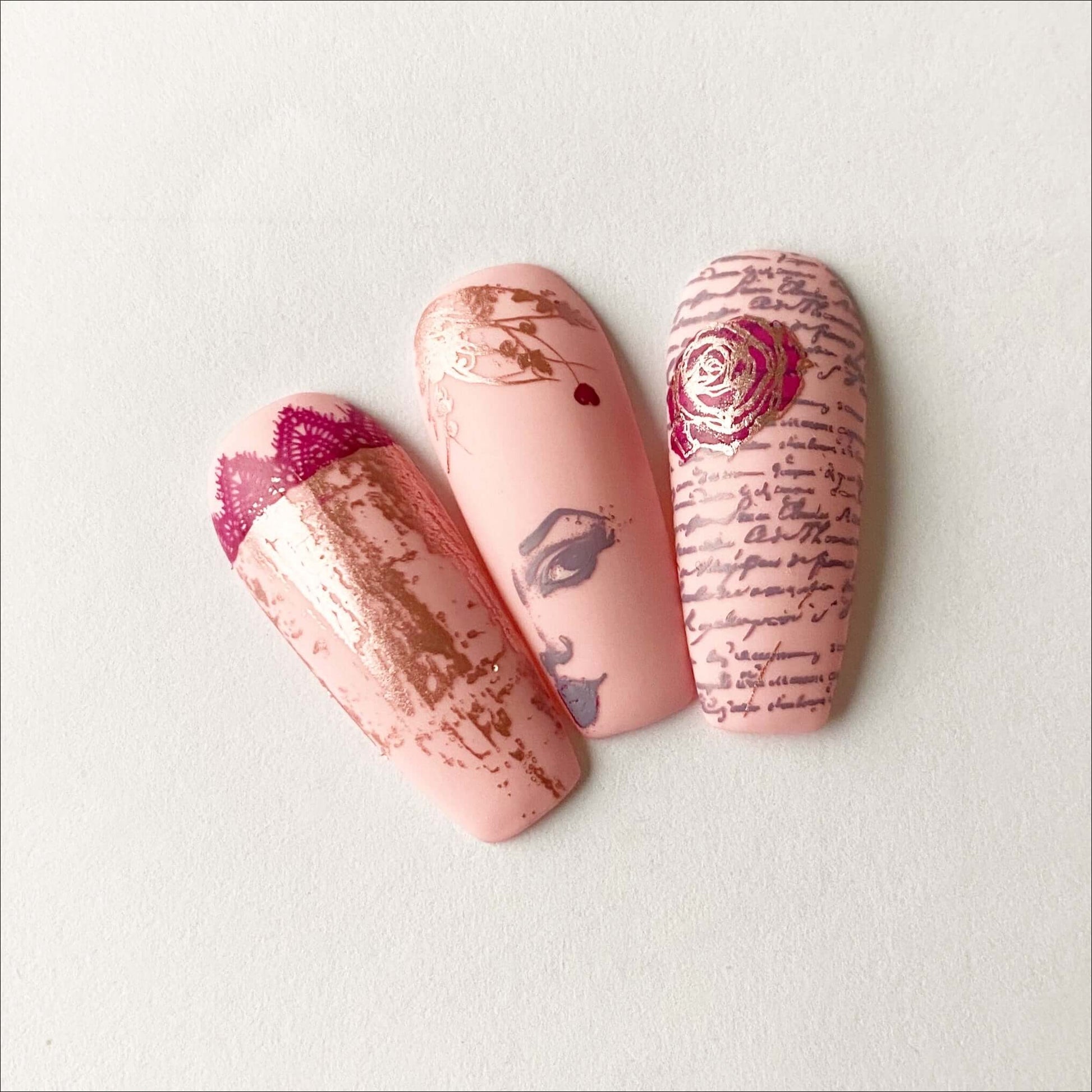 set-of-nail-tips-with-valentines-nail-art-designs-of-lace-a-rose-a-girls-face-and-script