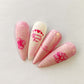 set-of-nail-tips-with-stunning-layered-nail-art-designs-of-flowers-hearts-and-script