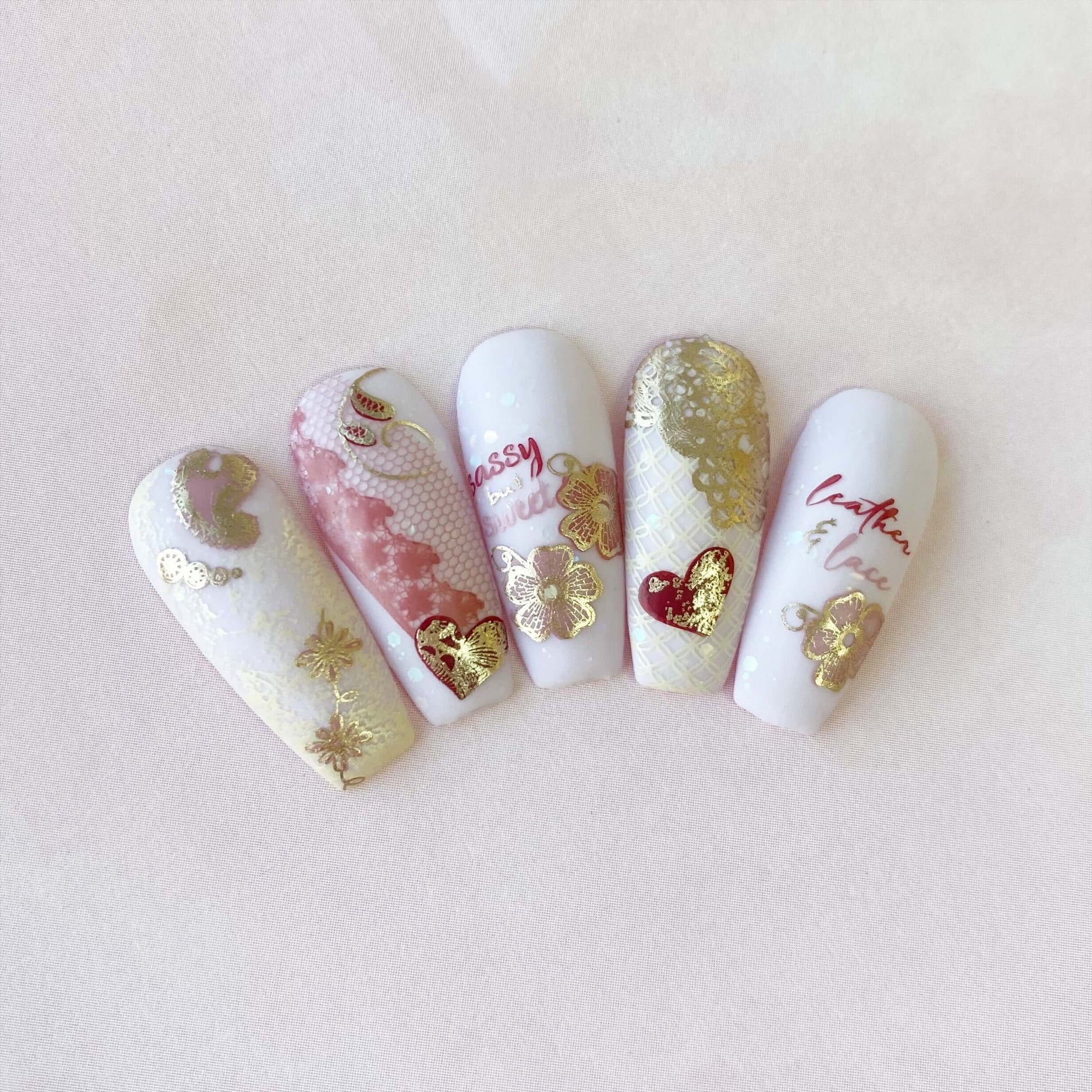 set-of-nail-tips-with-layered-nail-art-designs-of-lace-hearts-and-words-sassy-but-sweet
