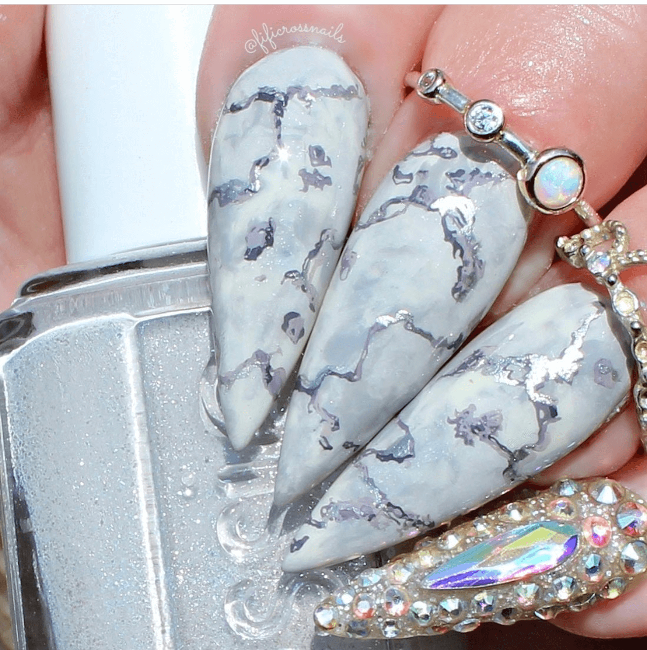 manicured-hand-with-full-coverage-nail-art-marble-designs