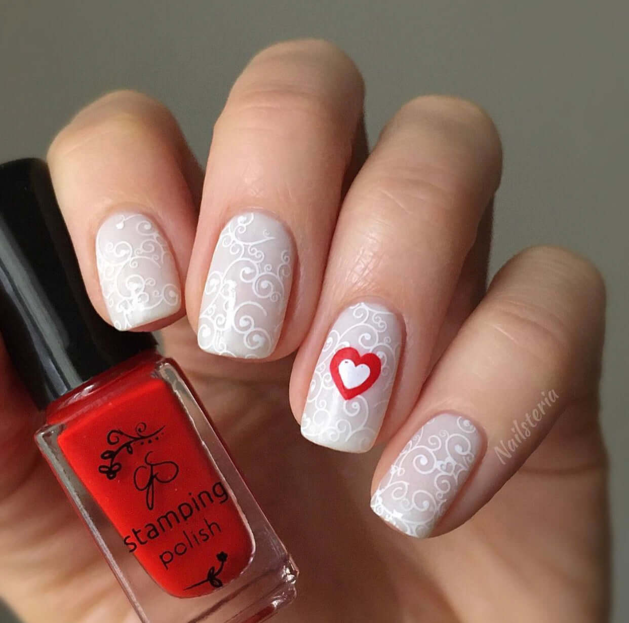 gorgeous-manicure-with-swirly-nail-art-and-a-solid-heart-design