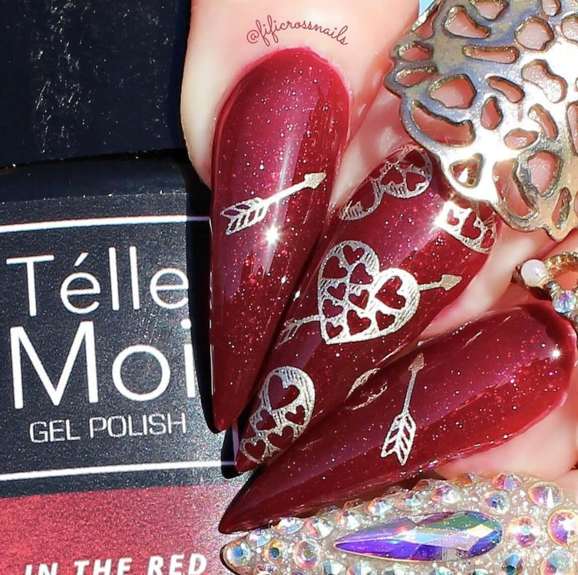 bright-manicure-with-nail-art-designs-of-arrow-shot-hearts